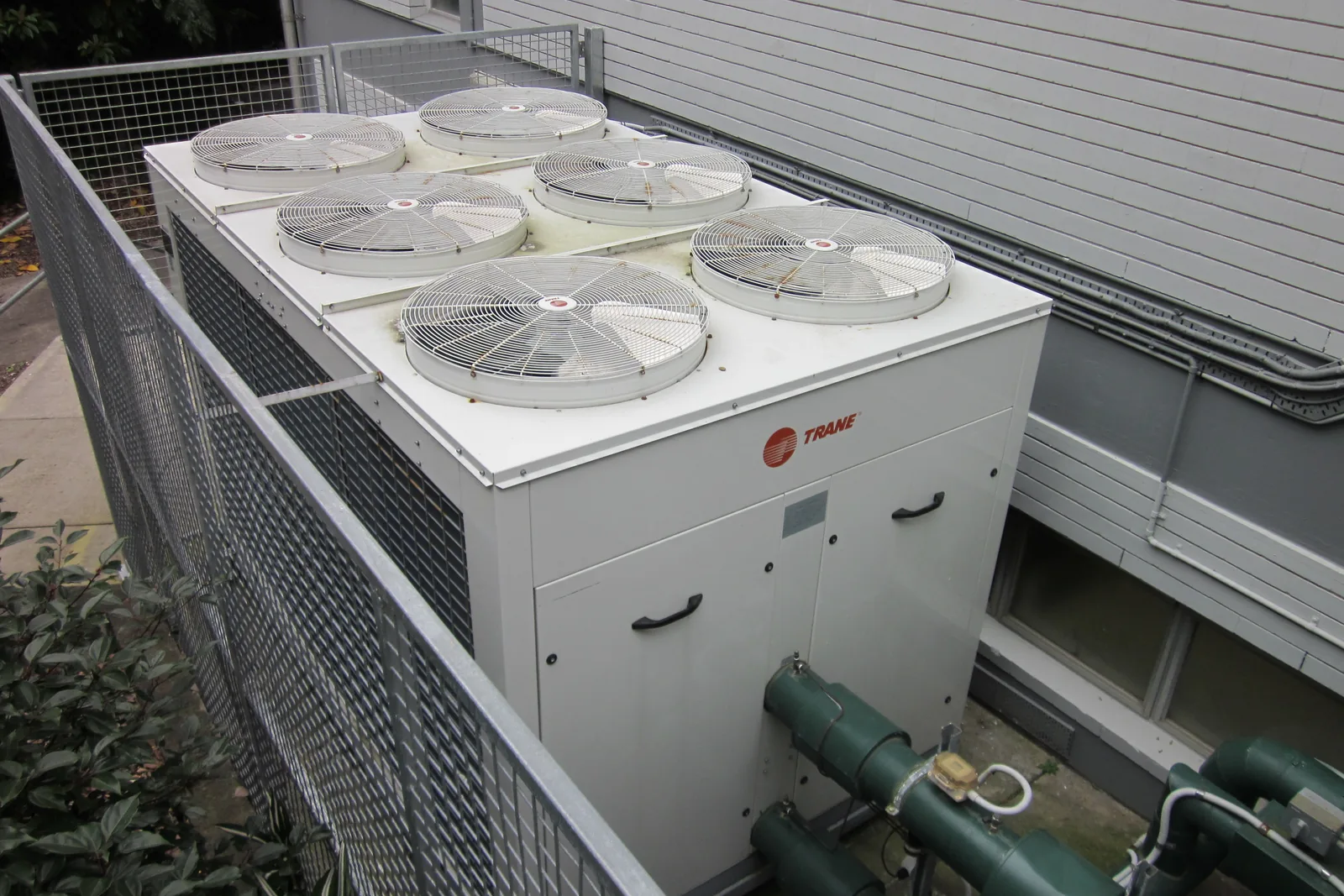 Technician performing preventative maintenance on commercial HVAC unit